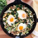 Green shakshuka with eggs, kale, spinach, and zucchini cooked in one pan for a healthy, energizing breakfast