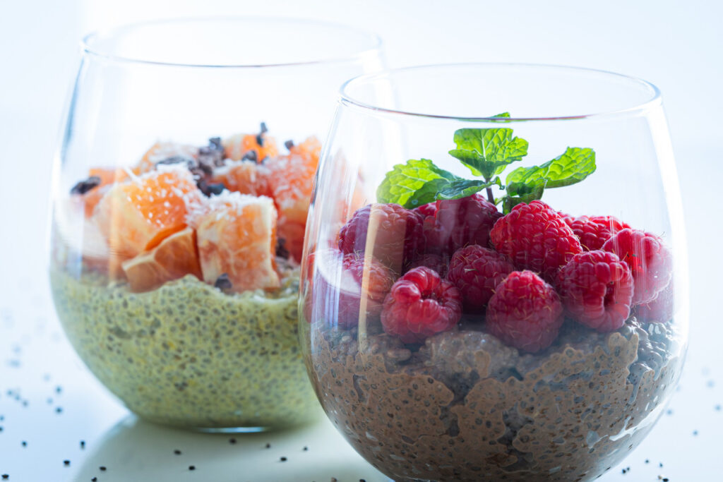 5-minute chocolate chia seed pudding in a glass jar topped with berries and cacao nibs