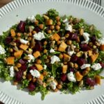 Roasted sweet potato and beet kale salad with feta, crunchy chickpeas, pistachios, and fresh kale — a colorful, nourishing salad that boosts energy and satisfies.