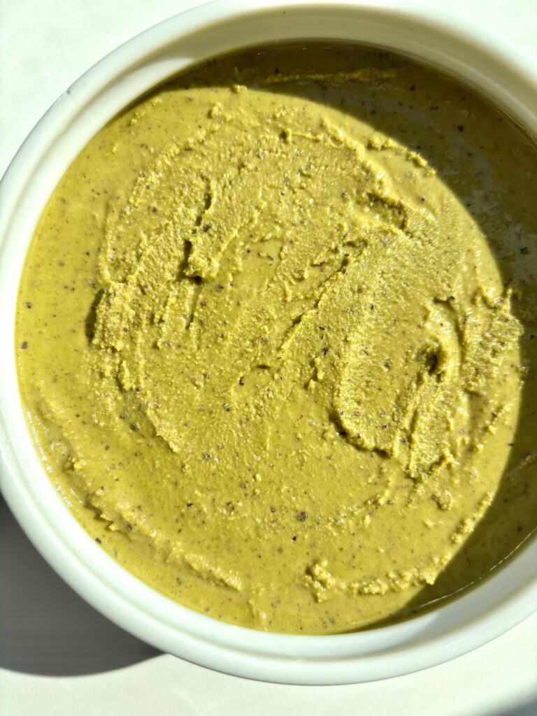 Creamy homemade pistachio butter in a jar, ultra smooth and naturally sweet with no added sugar