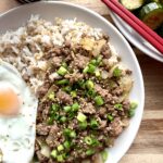 A bowl of easy Korean ground beef bulgogi served over rice with scallions and sesame seeds, a quick 20-minute high-protein Korean dinner.