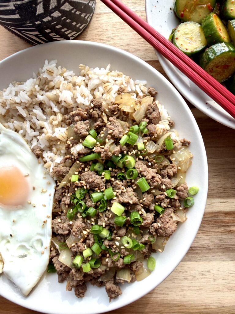 A bowl of easy Korean ground beef bulgogi served over rice with scallions and sesame seeds, a quick 20-minute high-protein Korean dinner.