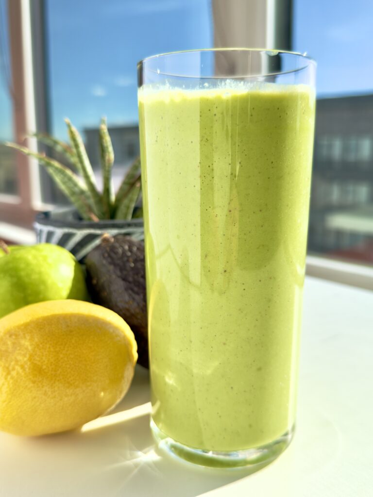 Low-glycemic green smoothie made with spinach, green apple, avocado, Greek yogurt, and seeds for steady energy and balanced blood sugar.